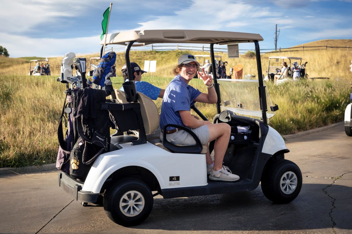 2026 Paws on the Green - golfer waives from cart